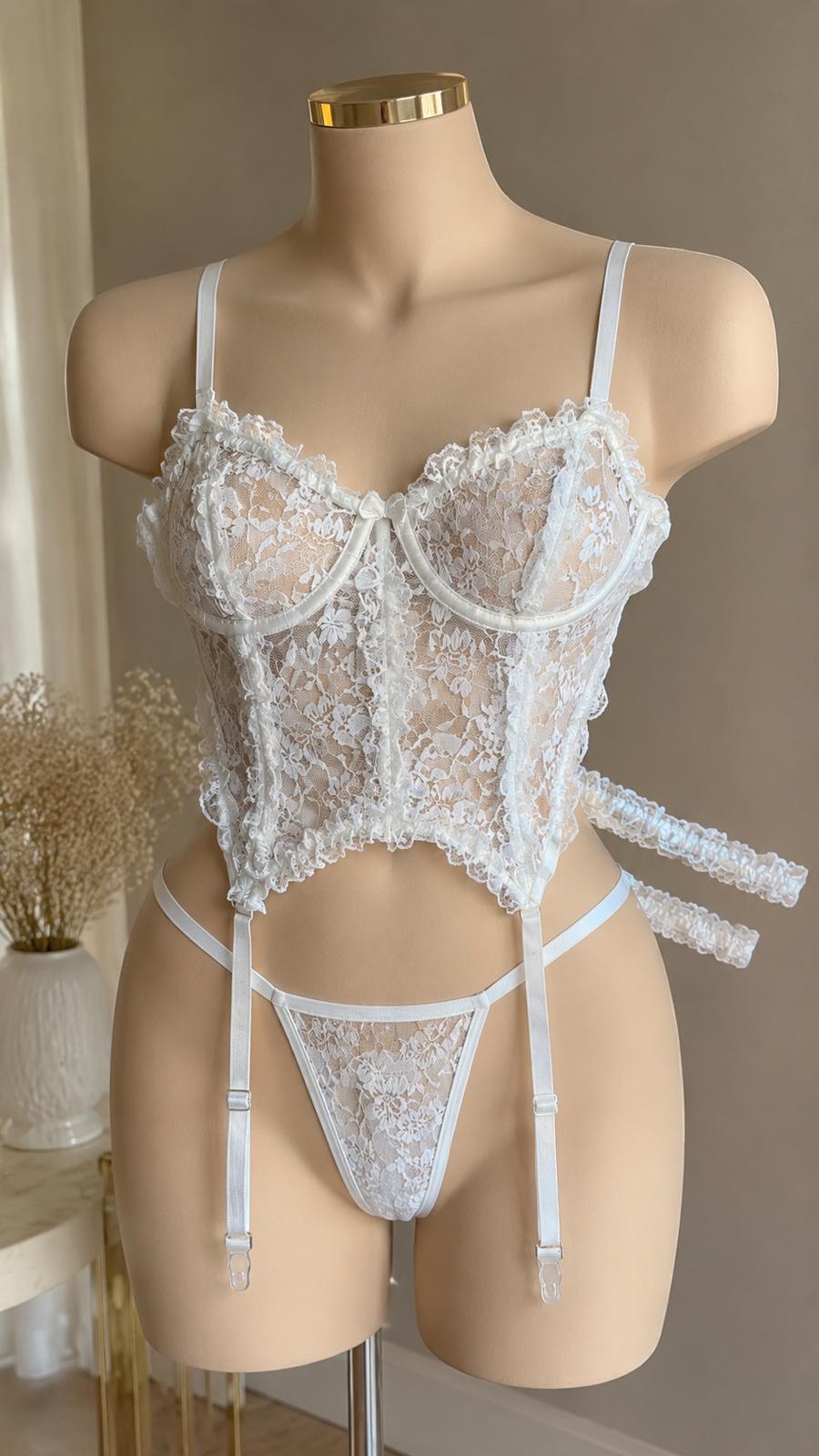 Woman wearing a white bridal lace lingerie set with bustier, thong and garter straps.